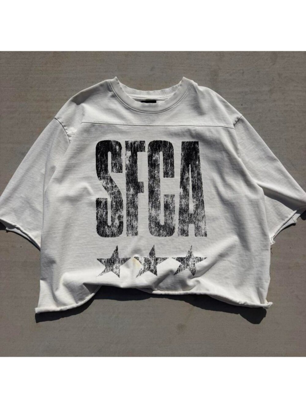 H&M white oversized tee with black distressed 'SFCA' text and three stars